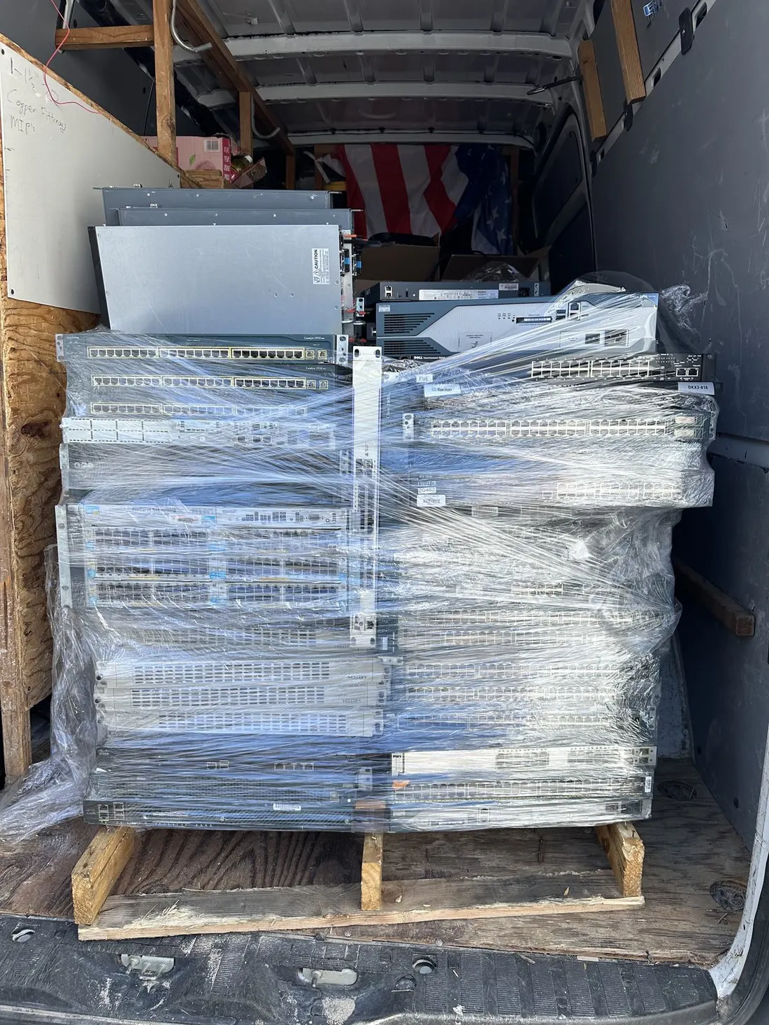 Wrapped network equipment staged inside a service van for infrastructure delivery