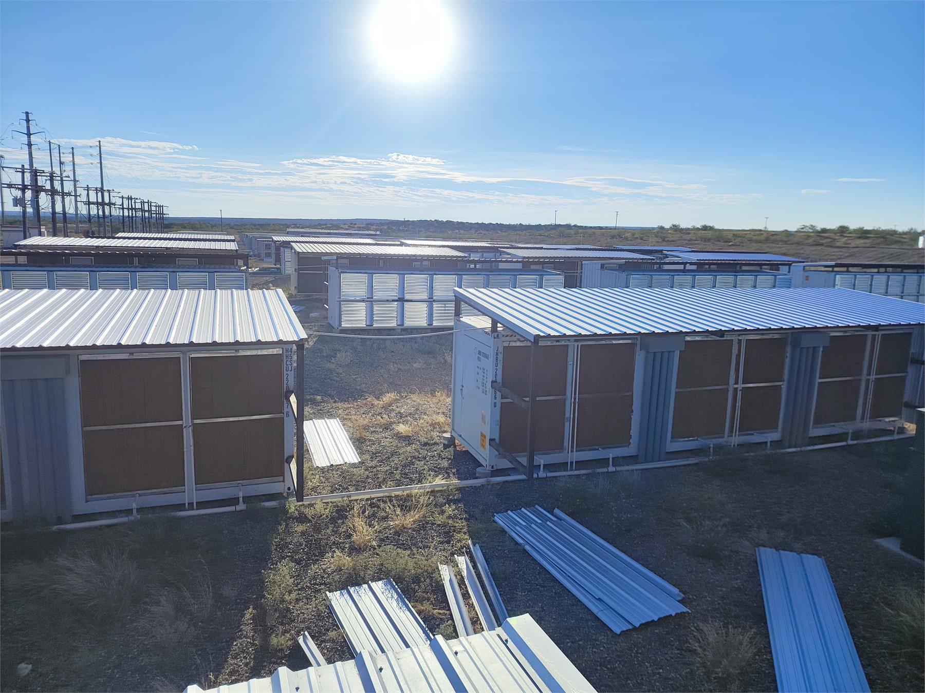Rows of outdoor data center cooling equipment and electrical infrastructure