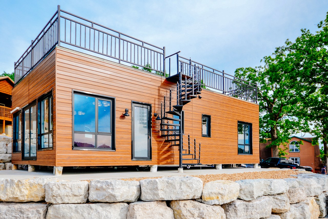 The Risetta completed tiny home with wood-look cladding and a rooftop deck